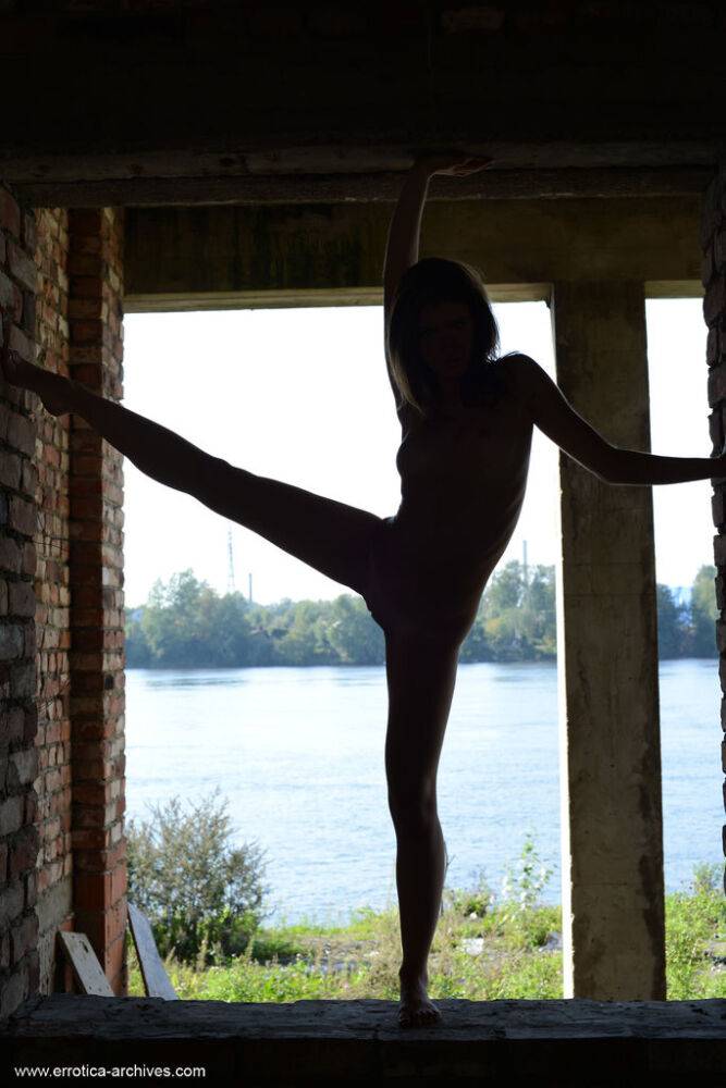 Teen solo girl Lara E strikes great nude poses against a brick veranda wall - #2