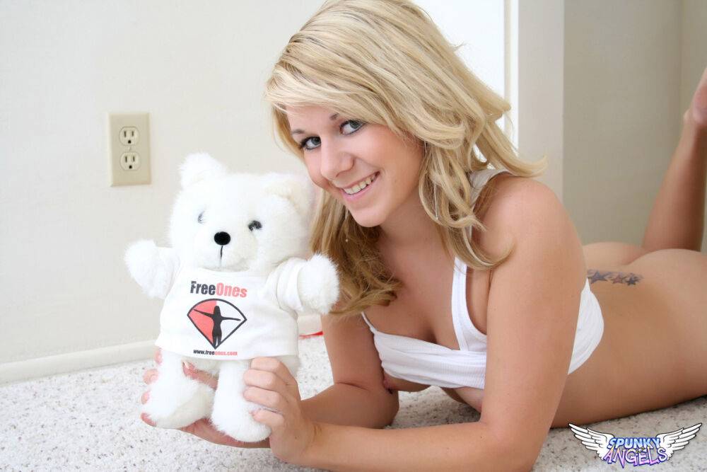 Cute blond Ashlee shows her tiny tits and bald slit with help from a plush toy - #9