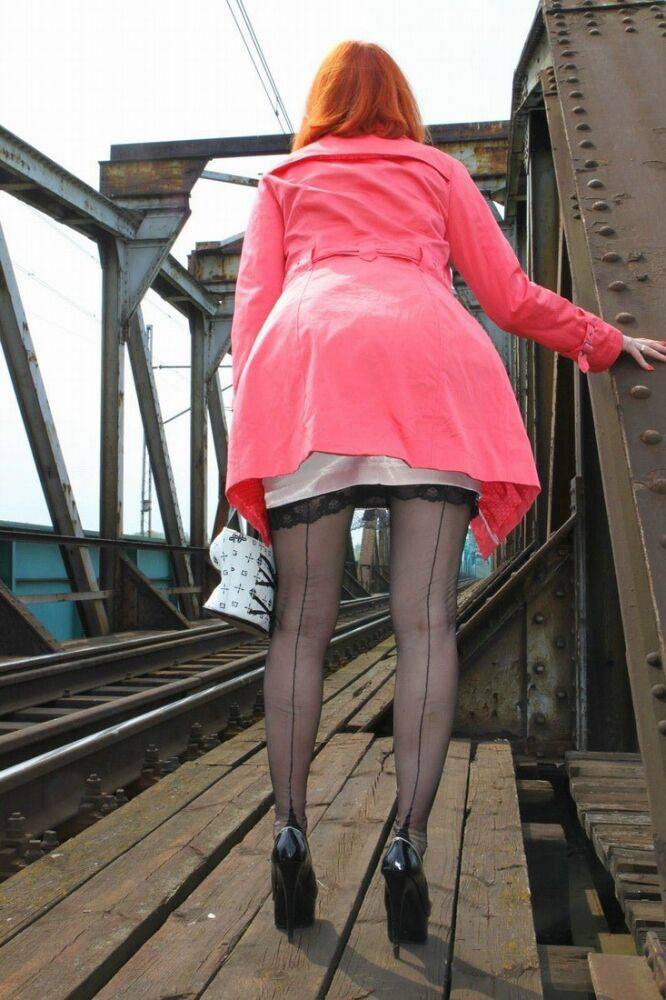 Redhead chick sports the no panty upskirt look on a train trestle - #4