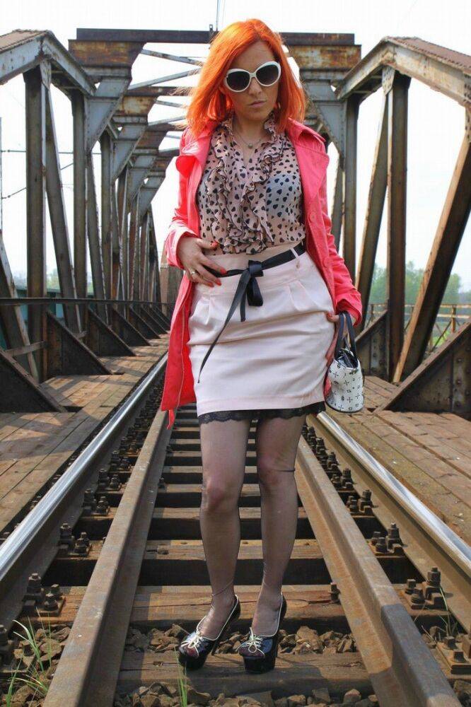 Redhead chick sports the no panty upskirt look on a train trestle - #1