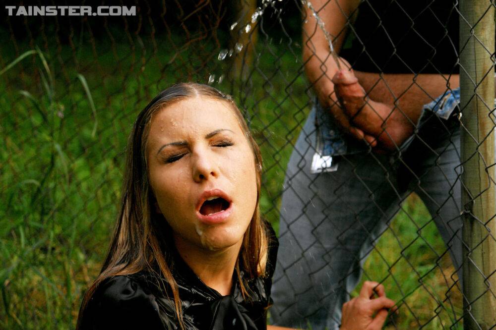 Clothed girl gets peed on after sucking off a cock thru a wire fence - #2