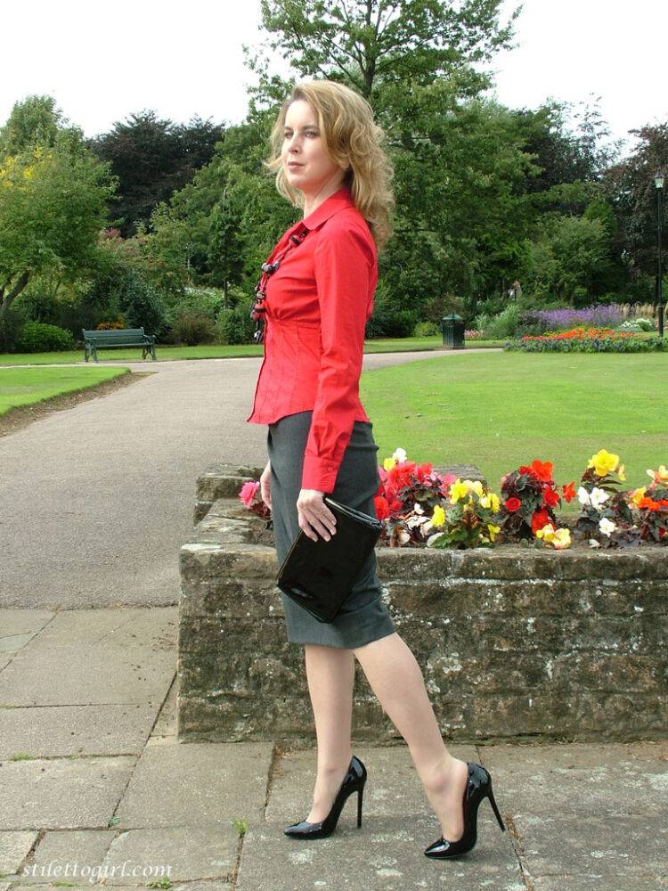 Fully clothed woman steps out of a stiletto heel while visiting a public park - #13