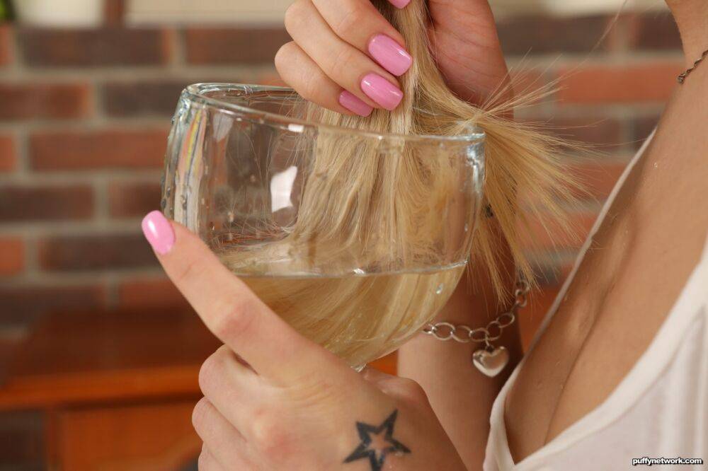 Young blonde Debora fills a glass with golden pee before drinking it - #2