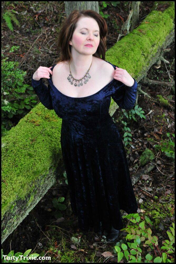 Mature woman Tasty Trixie heads into the woods to flash in a long velvet dress - #11