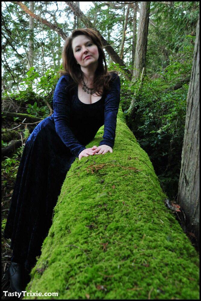 Mature woman Tasty Trixie heads into the woods to flash in a long velvet dress - #13