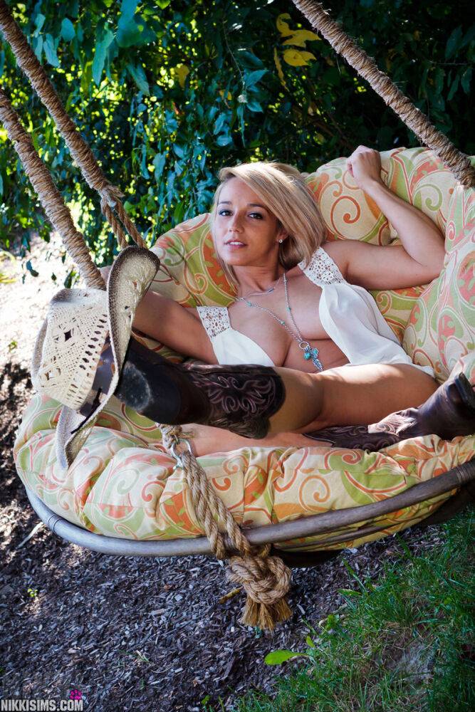 Blonde farm girl Nikki Sims teases in a straw hat and cowgirl boots on a swing - #14