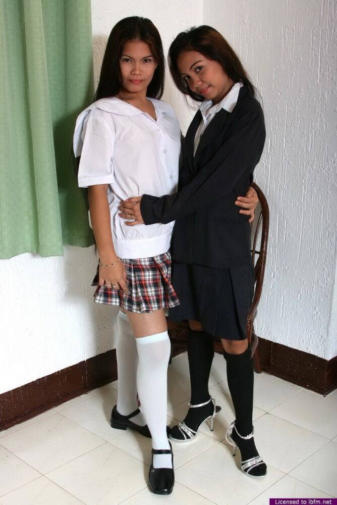 Asian schoolgirls share a lesbian kiss as they strip to over the knee socks - #6