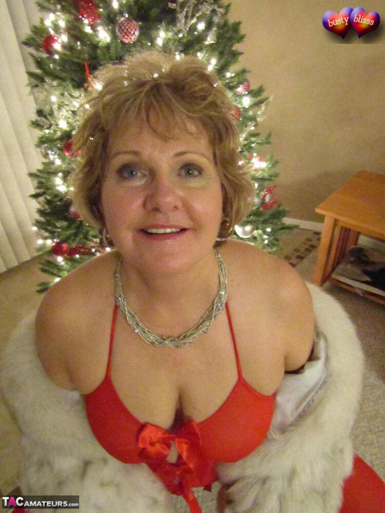 Older amateur Busty Bliss gives a blowjob in revealing lingerie at Christmas - #16