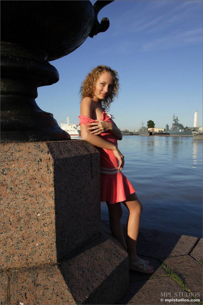 Curly haired girl exposes her pussy and small tits while hanging out on a pier - #7