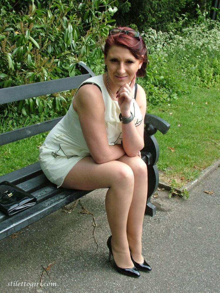 Thick woman in glasses shows off her stiletto heels on a park bench - #15