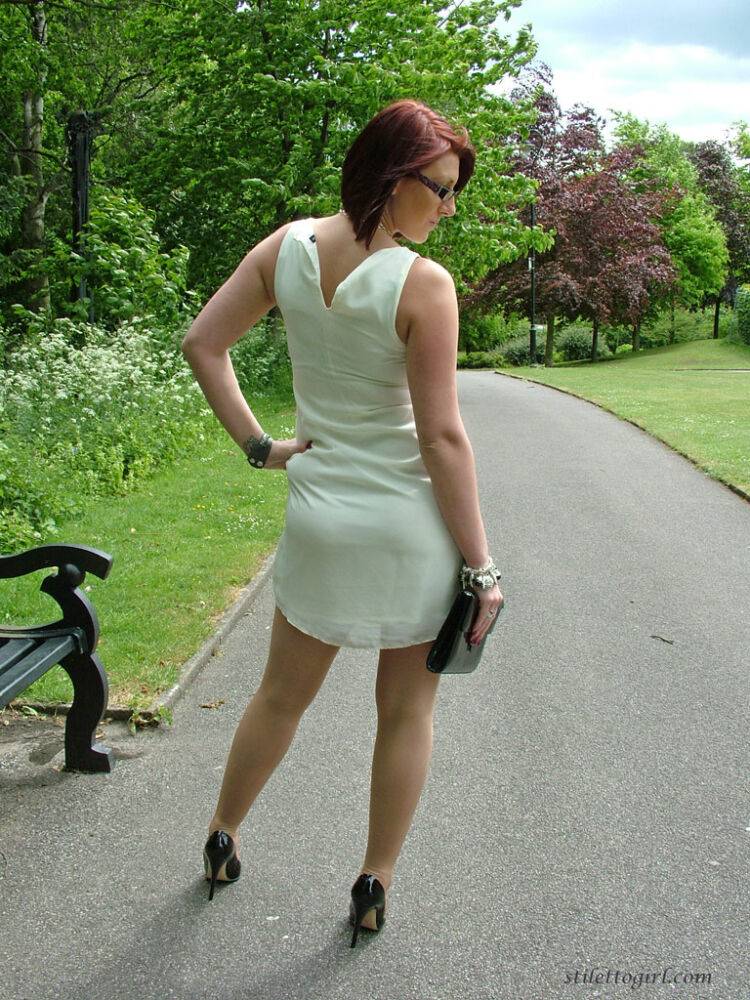 Thick woman in glasses shows off her stiletto heels on a park bench - #9