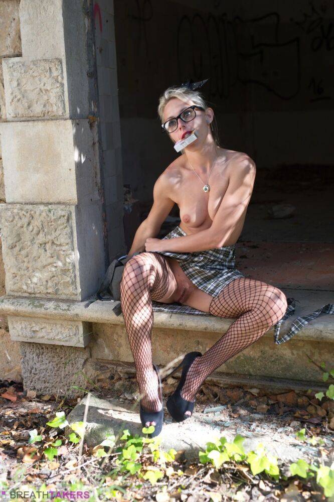 Nerdy girl Chloe Toy lights up outdoors while topless in a skirt and fishnets - #5