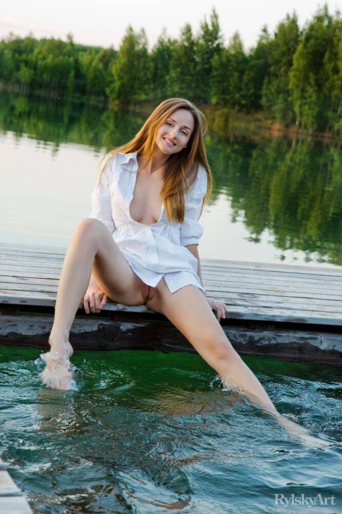 Slim teen Vittoria Amada dips her toes in lake before a nude modeling session - #1