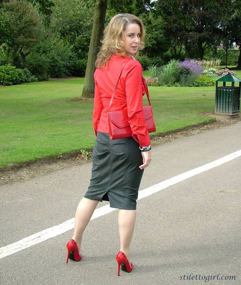 Mature woman crosses her hose covered legs in a long skirt and red pumps - #15