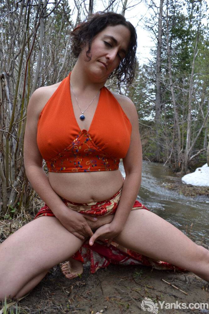 Busty amateur pets her beaver while bent over next to a brook in the woods - #7