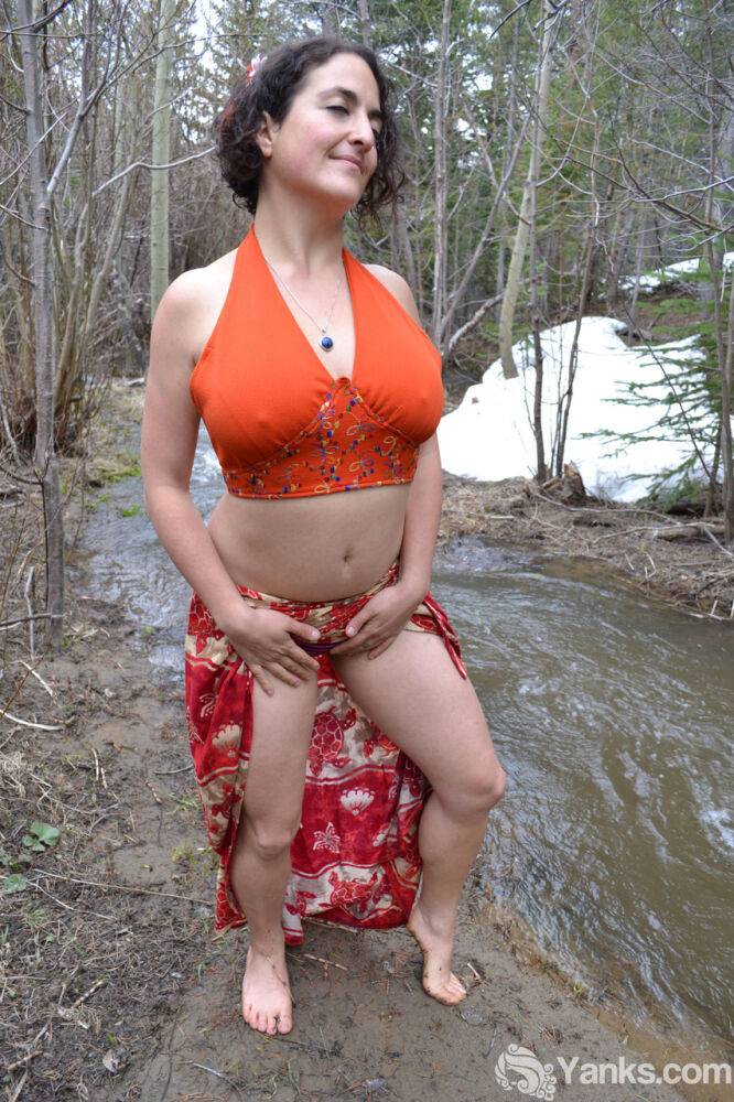 Busty amateur pets her beaver while bent over next to a brook in the woods - #9