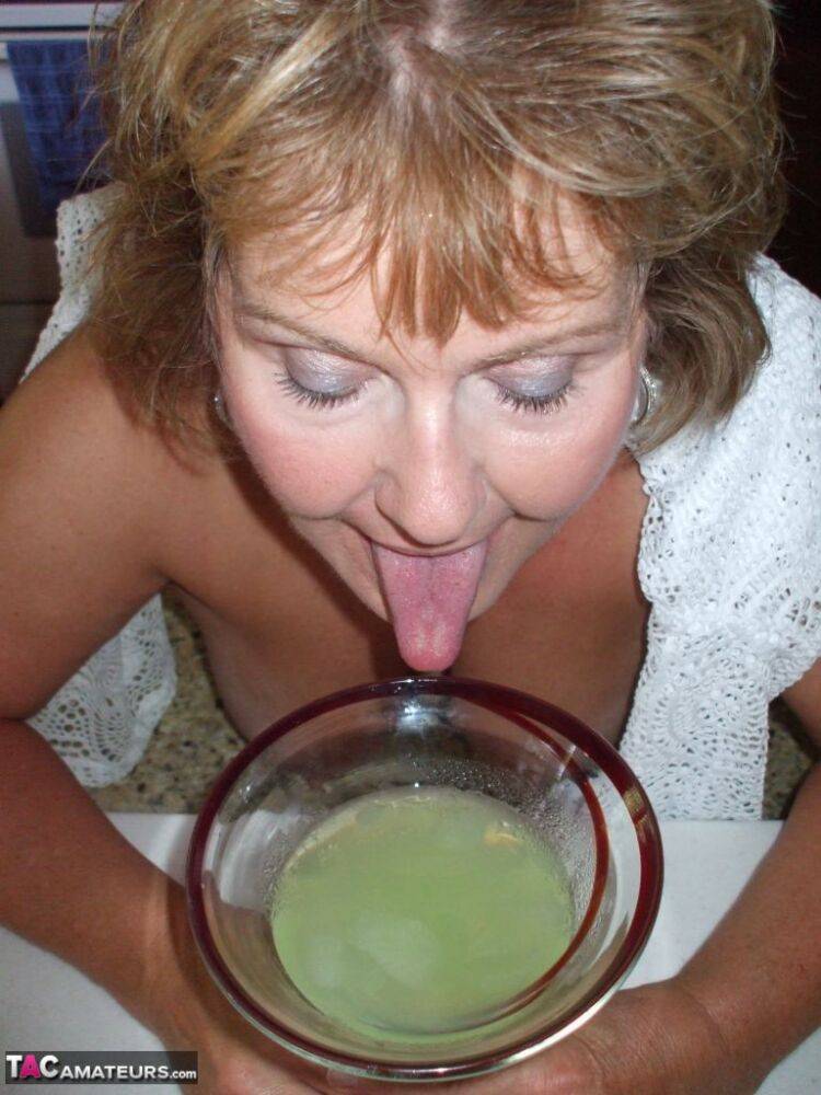 Mature amateur BustyBliss goes topless while enjoying a glass of booze - #7