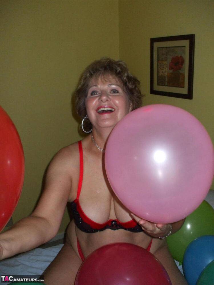 Older lady Busty Bliss plays with balloons before uncupping her natural tits - #1