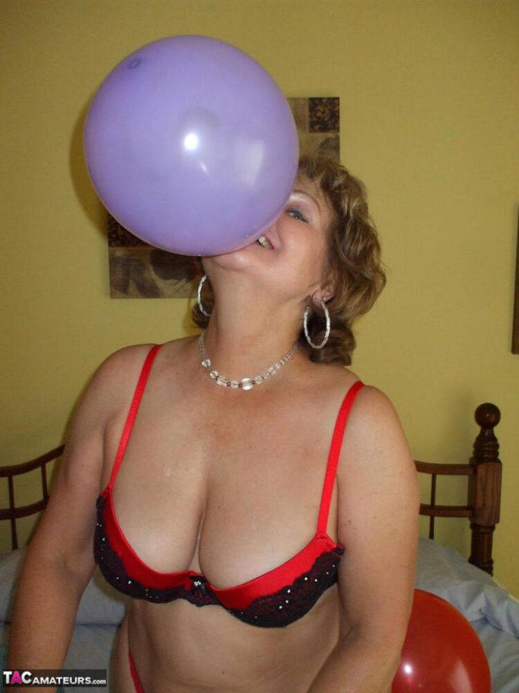 Older lady Busty Bliss plays with balloons before uncupping her natural tits - #16