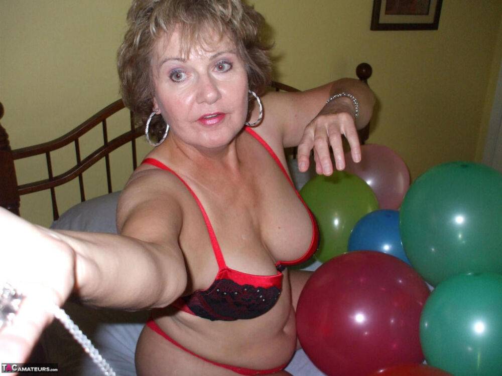 Older lady Busty Bliss plays with balloons before uncupping her natural tits - #12