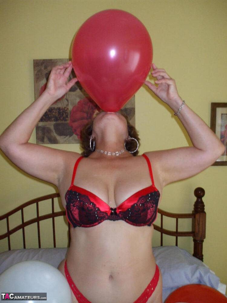 Older lady Busty Bliss plays with balloons before uncupping her natural tits - #8