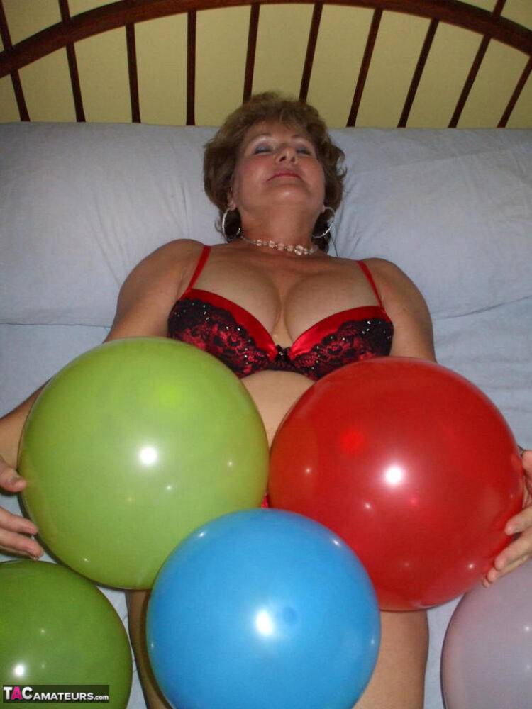 Older lady Busty Bliss plays with balloons before uncupping her natural tits - #3