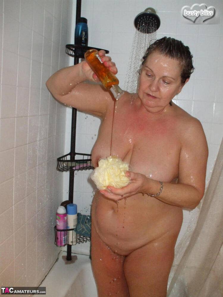 Mature lady Busty Bliss takes a cock in hand while showering at the same time - #15