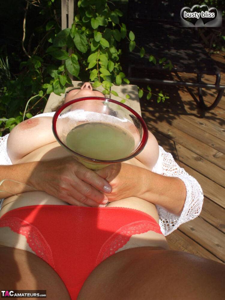 Mature woman Busty Bliss exposes her boobs while enjoying an alcoholic drink - #15