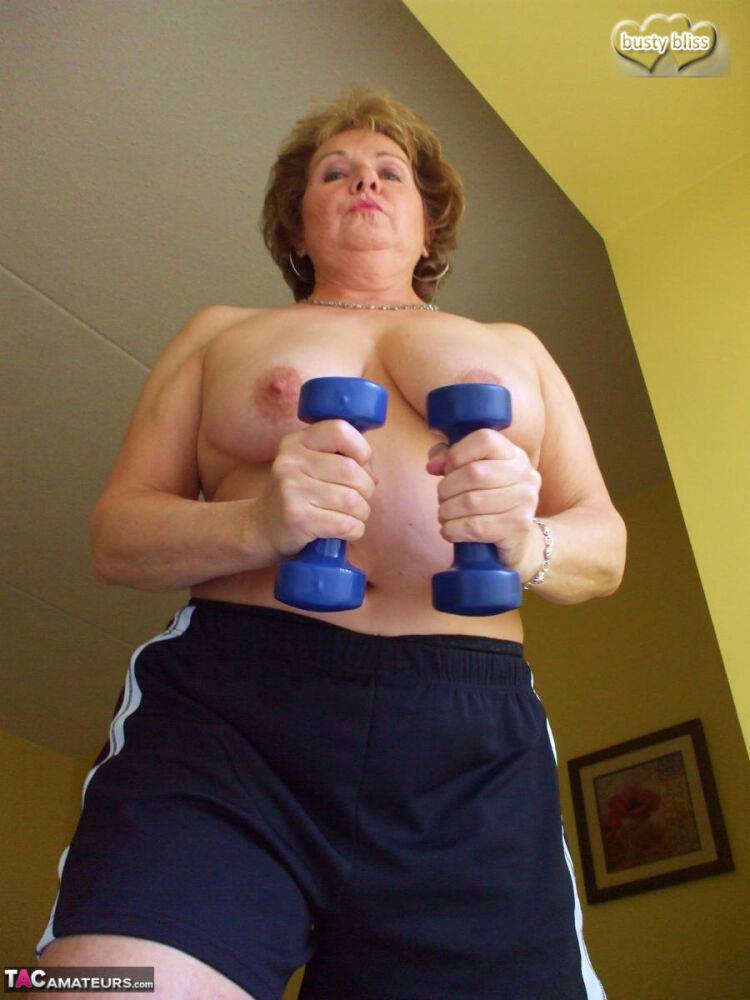 Middle-aged amateur Busty Bliss displays her big tits during a home workout - #10