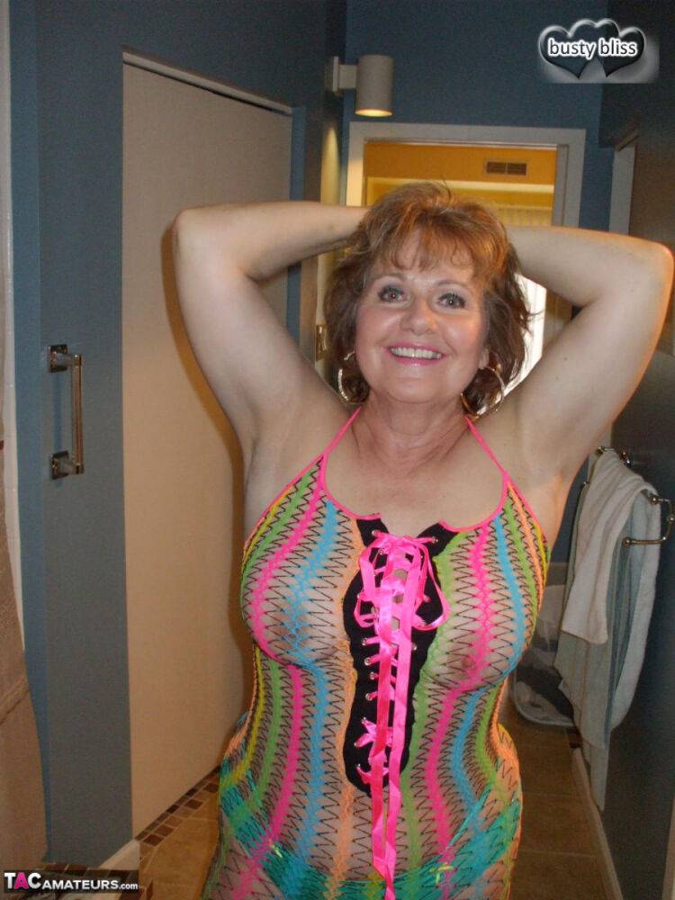 Redheaded granny Busty Bliss exposes her pussy in a see-through dress - #2