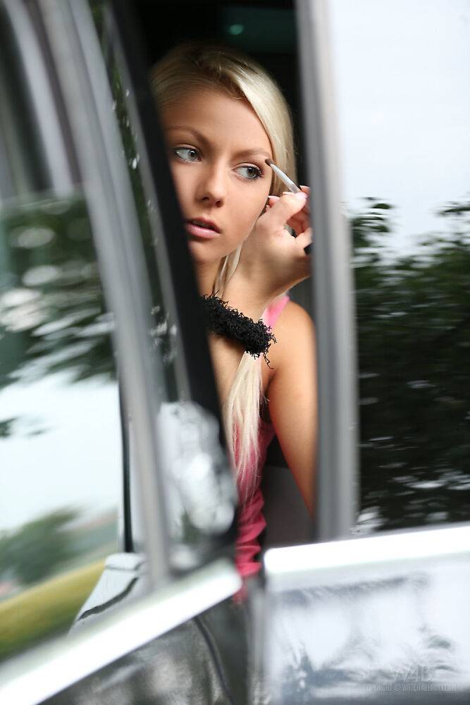 Beautiful blonde teen Grace puts out her smoke and models naked beside road - #13