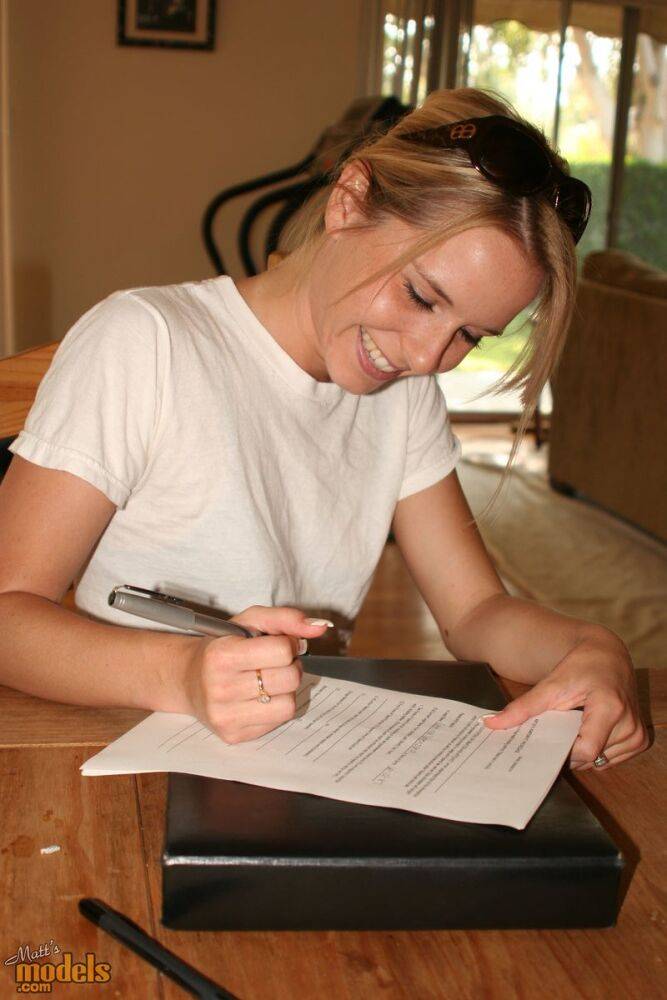 Young blonde stands naked before signing nude model release forms - #1