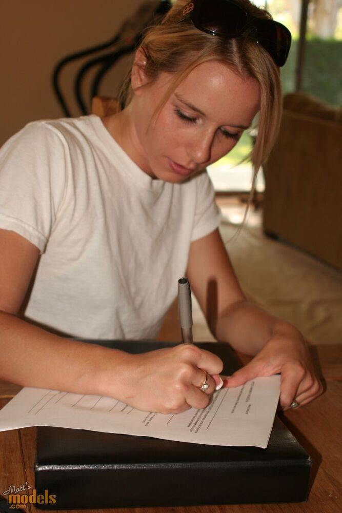 Young blonde stands naked before signing nude model release forms - #7