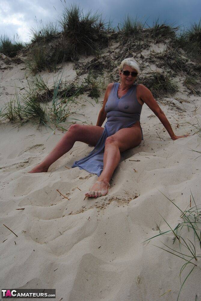 Mature platinum blonde Dimonty models at the beach in see through clothing - #15