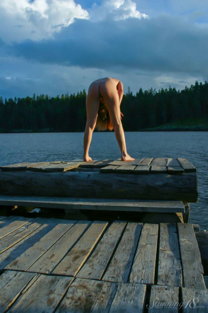 18-year-old girl Kristina models totally naked on a lakeside dock - #4