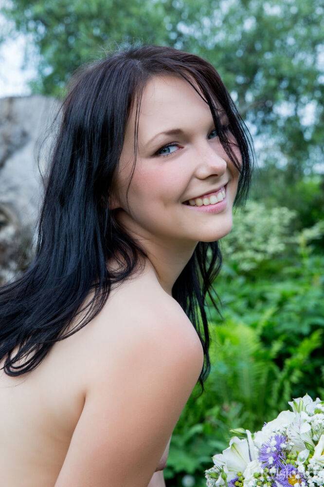 Petite teen Yvonne models totally naked on a wooden chair in the garden - #11