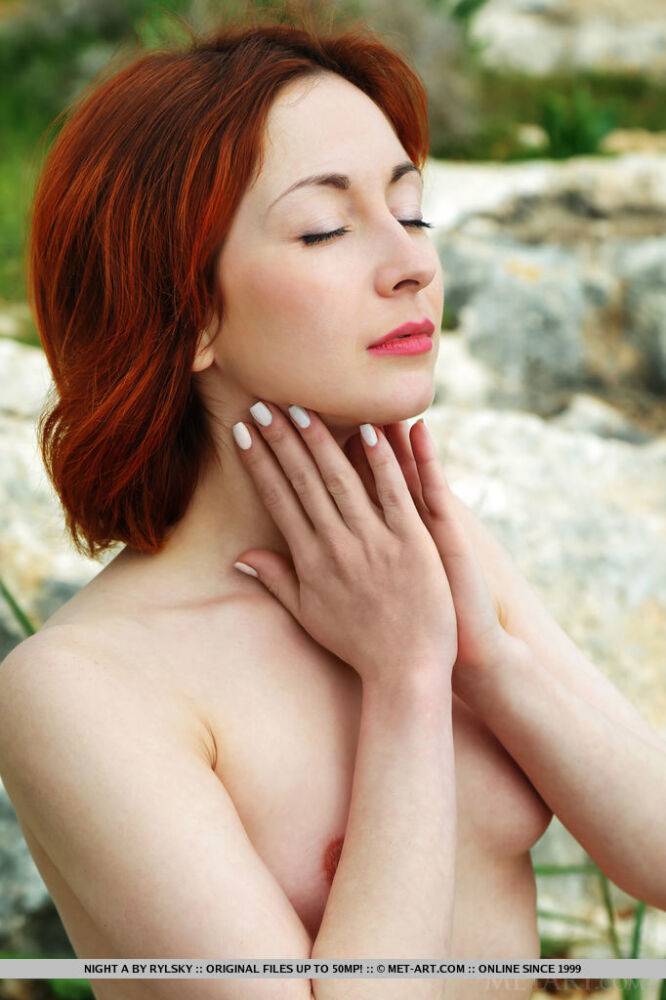Fair skinned redhead Night A models naked atop a hill overlooking her town - #1