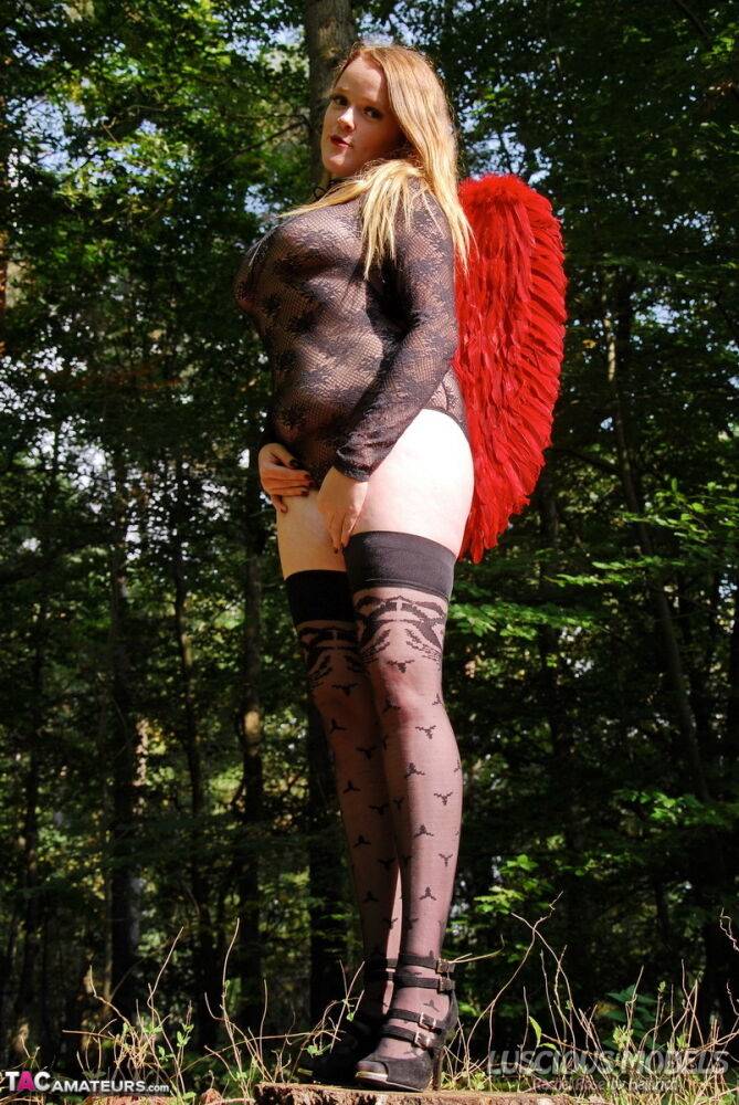 Redheaded amateur models lingerie and angel wings plus stockings in the woods - #1