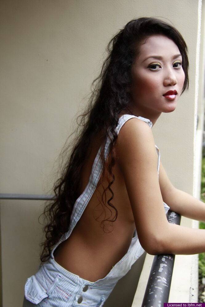 Petite Asian girl models in the nude after letting overall shorts fall aside - #6