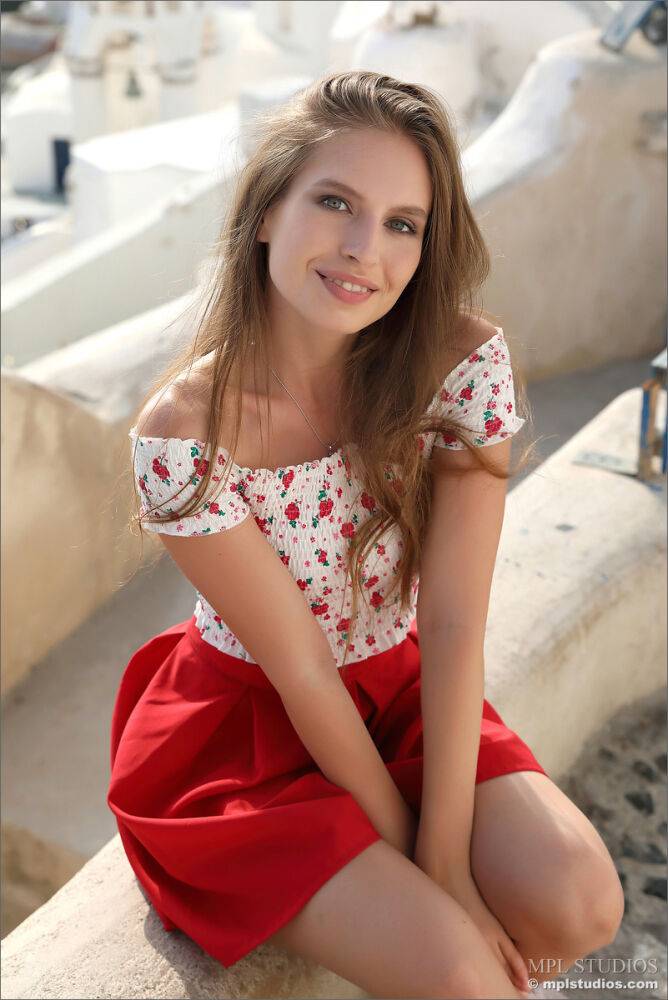 Pretty girl models fully clothed in a red skirt while on vacation - #7