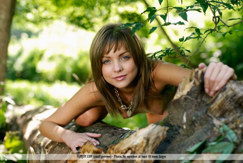 Petite girl Amelie models completely naked while in a forest - #8