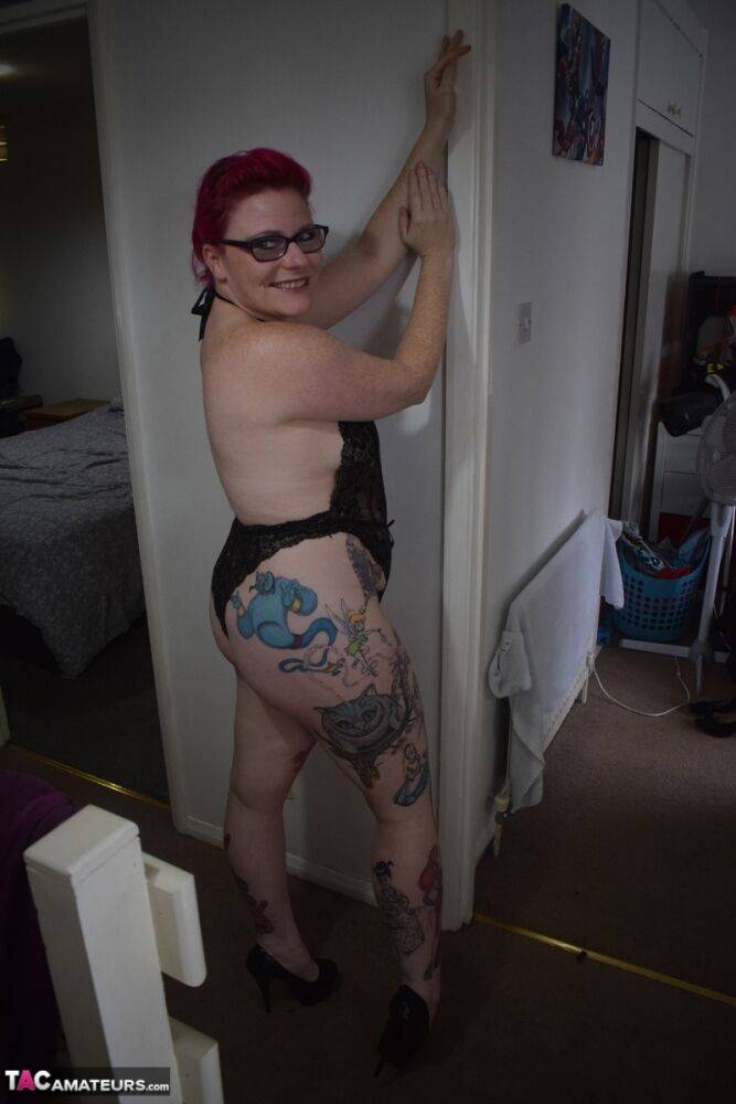 Tattooed redhead Mollie Foxxx models black lingerie with her glasses on | Photo: 2670896