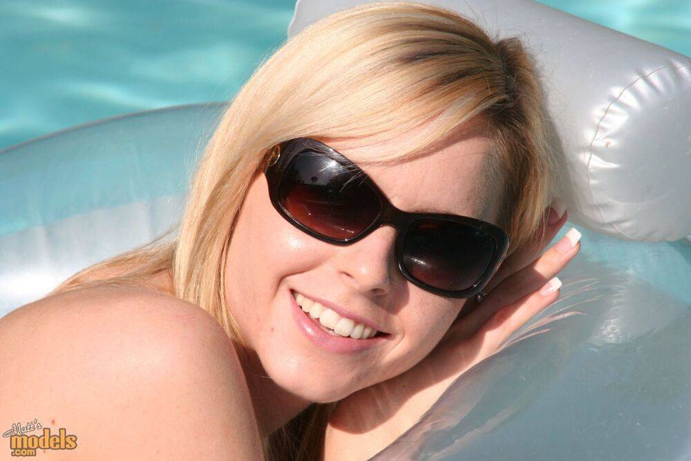 Blonde amateur Kara lounges on an air mattress in sunglasses only - #2