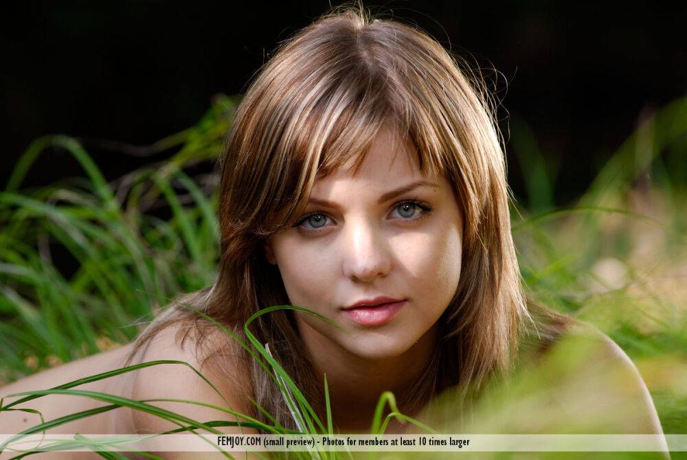 Young girl with striking eyes Amelie models totally naked along a stream - #12