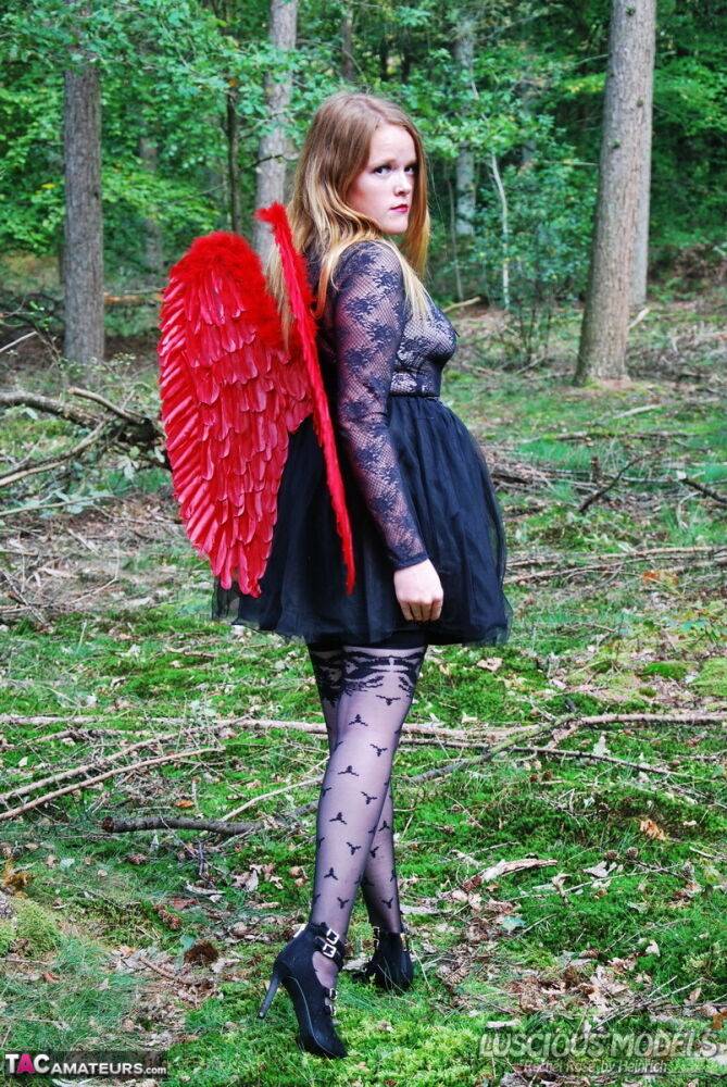 Amateur solo girl sports angel wings while modelling lingerie on a tree stump - #10