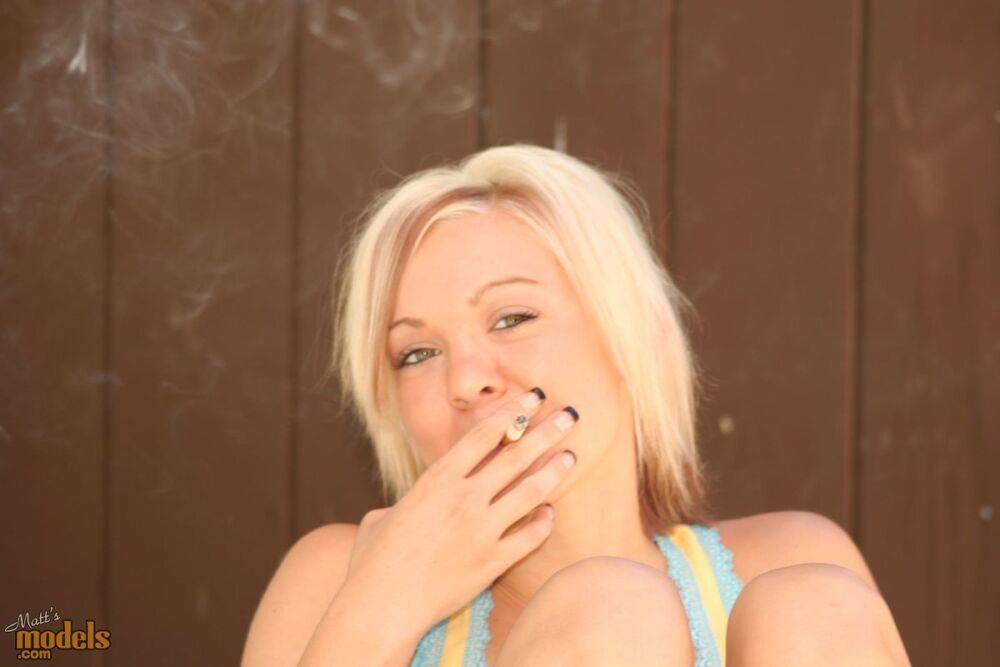 Blonde amateur Princessa smokes a cigarette after posing nude in a pool - #5