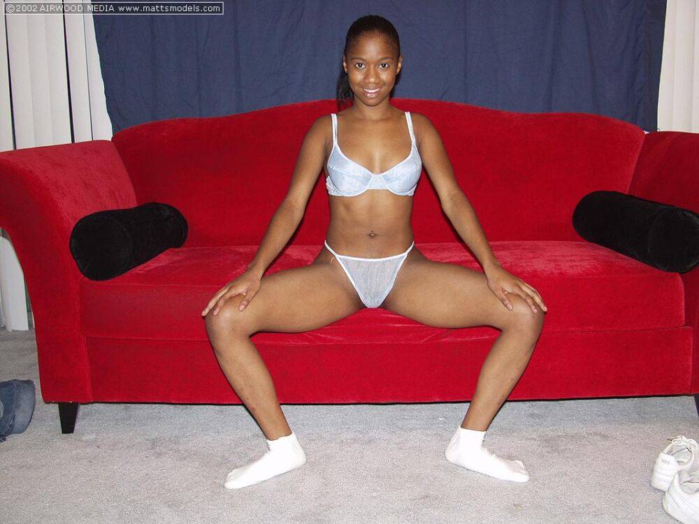 Black amateur Monique spreads her pussy lips after getting naked on a red sofa - #10