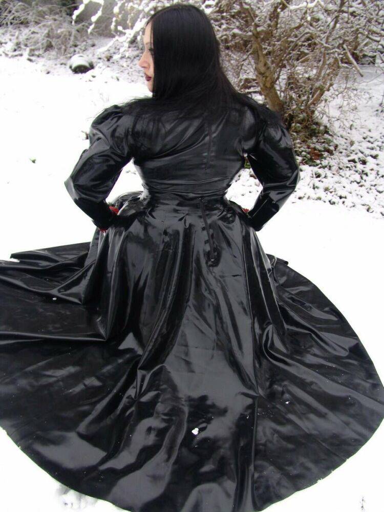 Goth woman Lady Angelina models a black latex dress on snow-covered ground - #6