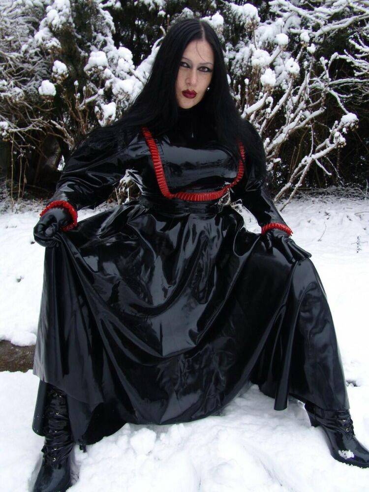 Goth woman Lady Angelina models a black latex dress on snow-covered ground - #14