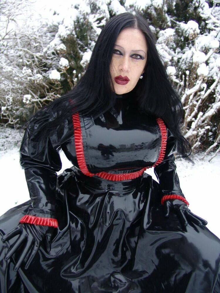 Goth woman Lady Angelina models a black latex dress on snow-covered ground - #7